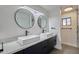 Modern bathroom featuring dual sinks, rectangular mirrors, and sleek fixtures at 5324 E Hillery Dr, Scottsdale, AZ 85254