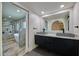Elegant bathroom featuring double vanities, a soaking tub, and marble-tiled shower at 5324 E Hillery Dr, Scottsdale, AZ 85254