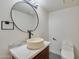 Stylish powder room with a round vessel sink, marble countertop and black faucet at 5324 E Hillery Dr, Scottsdale, AZ 85254
