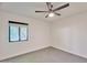 This bedroom has a ceiling fan and large window at 5324 E Hillery Dr, Scottsdale, AZ 85254