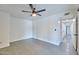 Bright bedroom featuring modern ceiling fan and light gray tile flooring at 5324 E Hillery Dr, Scottsdale, AZ 85254