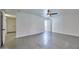 Bright bedroom with gray tile flooring, white walls, and a modern ceiling fan at 5324 E Hillery Dr, Scottsdale, AZ 85254