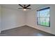 Minimalist bedroom with gray tile flooring and natural light from a bright window at 5324 E Hillery Dr, Scottsdale, AZ 85254