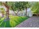 Inviting home with green lawn, desert landscaping, tall palms and walkway to front entrance at 5324 E Hillery Dr, Scottsdale, AZ 85254