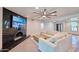 Cozy living room featuring a marble fireplace and modern ceiling fan at 5324 E Hillery Dr, Scottsdale, AZ 85254