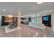 Open concept living room showcasing modern kitchen, dining area, fireplace and access to the backyard pool at 5324 E Hillery Dr, Scottsdale, AZ 85254