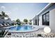A gorgeous backyard featuring a sparkling pool, lush plants and an outdoor lounge area at 5324 E Hillery Dr, Scottsdale, AZ 85254