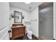 Well-lit bathroom with a single sink vanity, toilet, and a glass enclosed shower at 5435 E Cambridge Ave, Phoenix, AZ 85008