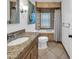 Neutral toned bathroom features a granite vanity, tile flooring, and tiled shower and tub at 5435 E Cambridge Ave, Phoenix, AZ 85008