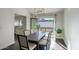Bright dining room with a modern table set, large windows, and access to an outdoor patio at 5435 E Cambridge Ave, Phoenix, AZ 85008