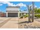Contemporary home with a two-car garage, desert landscaping, and a well-maintained front yard at 5435 E Cambridge Ave, Phoenix, AZ 85008