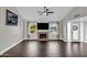 Bright living room with vaulted ceiling, fireplace, large windows, and elegant wood-look tile flooring at 5435 E Cambridge Ave, Phoenix, AZ 85008