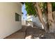 Private backyard area with mature trees and gravel landscaping at 5909 E Aire Libre Ln, Scottsdale, AZ 85254