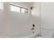 Updated bathroom with sleek black fixtures and a tiled tub/shower combo at 5909 E Aire Libre Ln, Scottsdale, AZ 85254