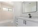 Bright bathroom with a modern vanity, elegant mirror, and tiled shower at 5909 E Aire Libre Ln, Scottsdale, AZ 85254