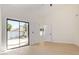 Bright bedroom with light hardwood floors and view to a backyard pool at 5909 E Aire Libre Ln, Scottsdale, AZ 85254