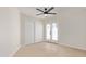 Bright bedroom featuring sliding closet doors, ceiling fan, and double doors to the backyard at 5909 E Aire Libre Ln, Scottsdale, AZ 85254