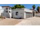 White stucco home showcasing a terracotta roof, gray garage door, and low maintenance desert landscaping at 5909 E Aire Libre Ln, Scottsdale, AZ 85254