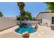 Backyard pool with rock features, surrounded by mature trees, and a serene atmosphere at 5909 E Aire Libre Ln, Scottsdale, AZ 85254