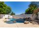 Beautiful backyard pool featuring rock accents and landscaping for a serene retreat at 5909 E Aire Libre Ln, Scottsdale, AZ 85254