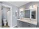 Well-lit bathroom with a double sink vanity and a shower with new modern finishes at 6550 W Wolf St, Phoenix, AZ 85033
