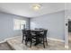 Cozy dining area with wood-look tile flooring and natural light from the window at 6550 W Wolf St, Phoenix, AZ 85033