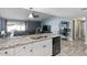 Bright open kitchen with granite countertops, stainless steel sink, and black appliances at 6550 W Wolf St, Phoenix, AZ 85033