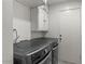 Modern laundry room with high-end washer and dryer, plus built-in storage cabinets at 6550 W Wolf St, Phoenix, AZ 85033