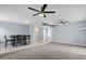 Spacious living room flows seamlessly into dining area, featuring dual ceiling fans at 6550 W Wolf St, Phoenix, AZ 85033