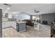 Open-concept living space with modern kitchen flowing into a comfortable seating area at 6550 W Wolf St, Phoenix, AZ 85033