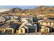 Aerial view of a neighborhood nestled among desert mountains, featuring tile roofs at 6954 W Maya Way, Peoria, AZ 85383