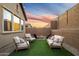 Inviting backyard featuring a cozy fire pit surrounded by comfortable seating and ambient string lights at 6954 W Maya Way, Peoria, AZ 85383