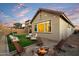 Backyard with artificial turf and chairs around a fire pit, perfect for outdoor gatherings at 6954 W Maya Way, Peoria, AZ 85383