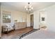 Cozy bedroom with natural light, hardwood flooring, and a decorative chandelier at 6954 W Maya Way, Peoria, AZ 85383