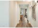 Bright hallway featuring hardwood floors, sconces, and artwork, leading to the living area at 6954 W Maya Way, Peoria, AZ 85383