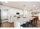 Bright kitchen features white cabinetry, granite countertops, stainless appliances and a large island with seating at 6954 W Maya Way, Peoria, AZ 85383