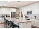 Bright kitchen features white cabinetry, granite countertops, stainless appliances and a large island with seating at 6954 W Maya Way, Peoria, AZ 85383