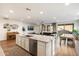 Bright kitchen features white cabinetry, granite countertops, stainless appliances and an open floor plan at 6954 W Maya Way, Peoria, AZ 85383