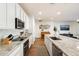 Bright kitchen features white cabinetry, granite countertops, stainless appliances and a large island with seating at 6954 W Maya Way, Peoria, AZ 85383