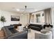 Comfortable living room with stylish decor, modern lighting, and comfortable seating arrangement at 6954 W Maya Way, Peoria, AZ 85383