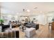 Expansive living area flows into kitchen featuring an open floor plan, wood floors, and plenty of natural light at 6954 W Maya Way, Peoria, AZ 85383