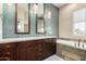 Modern bathroom featuring dual sinks, a large mirror, and a standalone tub at 7400 E Gainey Club Dr # 203, Scottsdale, AZ 85258