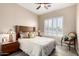 Bedroom with large window and a decorative chair, with light-colored bedding at 7400 E Gainey Club Dr # 203, Scottsdale, AZ 85258