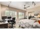 Bedroom doubling as an office space with a large window and a ceiling fan at 7400 E Gainey Club Dr # 203, Scottsdale, AZ 85258