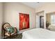 Bedroom with neutral paint and tile flooring featuring an ornate chair and modern art at 7400 E Gainey Club Dr # 203, Scottsdale, AZ 85258