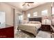 Comfortable bedroom with a neutral color scheme, balcony access, and decorative lamps at 7400 E Gainey Club Dr # 203, Scottsdale, AZ 85258