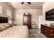 Neutral toned bedroom featuring a ceiling fan, tile floors, and wooden accents at 7400 E Gainey Club Dr # 203, Scottsdale, AZ 85258