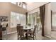 Bright dining area with large windows, plantation shutters, and access to an outdoor patio at 7400 E Gainey Club Dr # 203, Scottsdale, AZ 85258