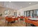 Bright dining area with modern tables and chairs, complemented by a stylish mirror and pendant lighting at 7400 E Gainey Club Dr # 203, Scottsdale, AZ 85258