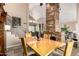 Open-concept dining area highlighting an eye-catching stone pillar and staircase adding architectural interest at 7400 E Gainey Club Dr # 203, Scottsdale, AZ 85258